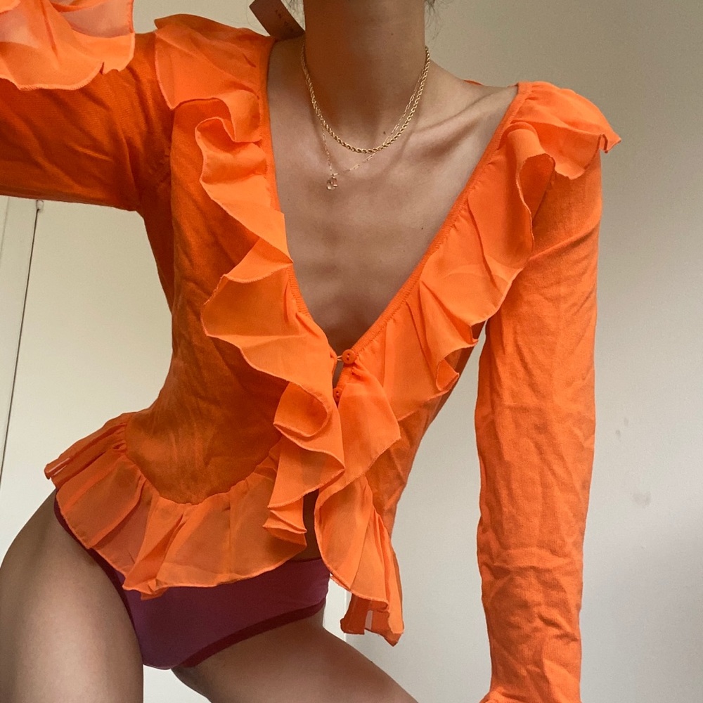 orange ruffled blouse
